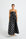 Woman wearing a black strapless midi dress with white polka dots