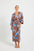 Woman wearing a blue and brown floral print wrap midi dress. 