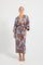 Woman wearing a blue and brown floral print wrap midi dress. 