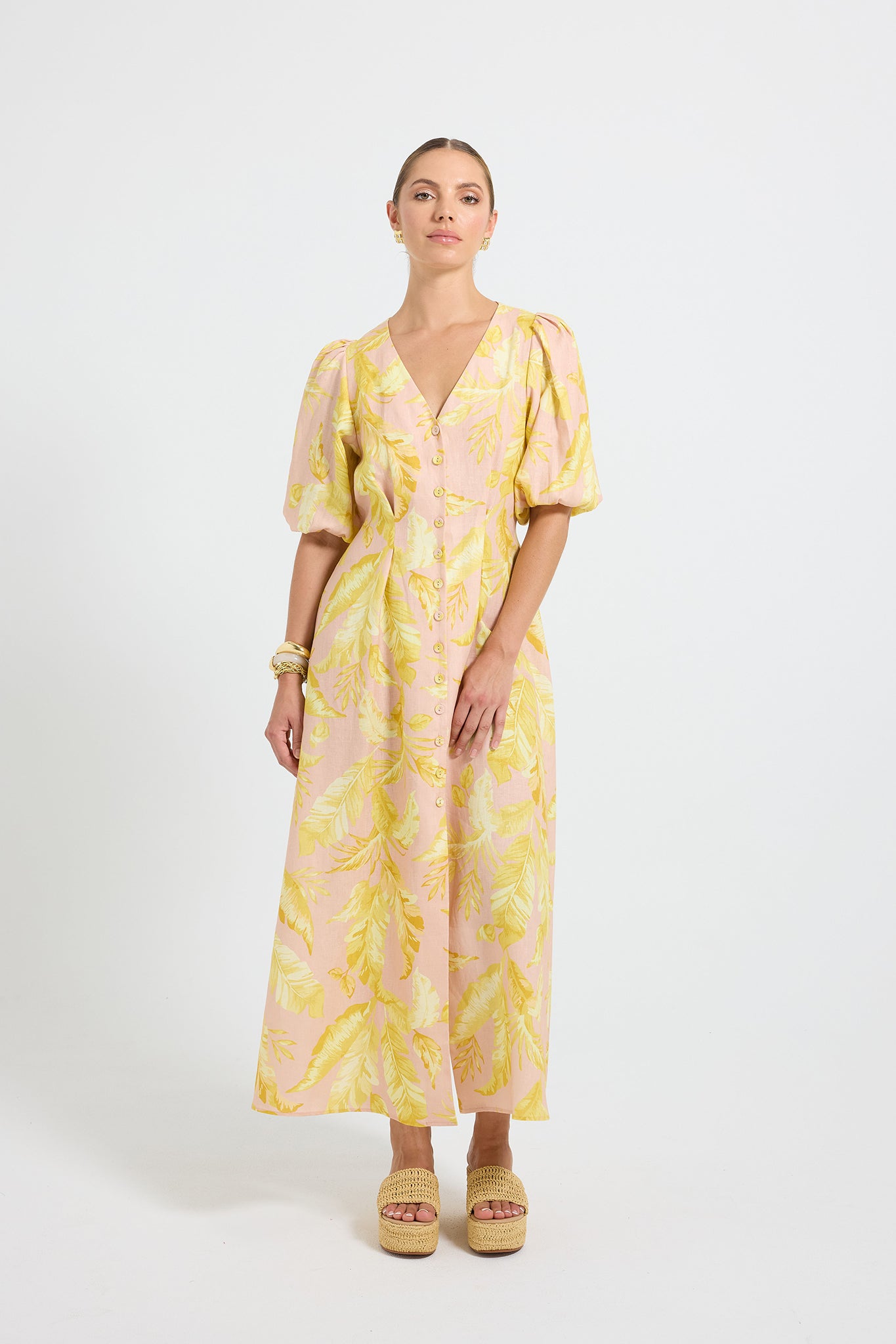 Woman wearing a yellow and pink palm print Midi Shirt Dress