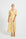 Woman wearing a yellow and pink palm print Midi Shirt Dress
