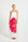 Woman wearing a strapless dress with a large pink flower design.