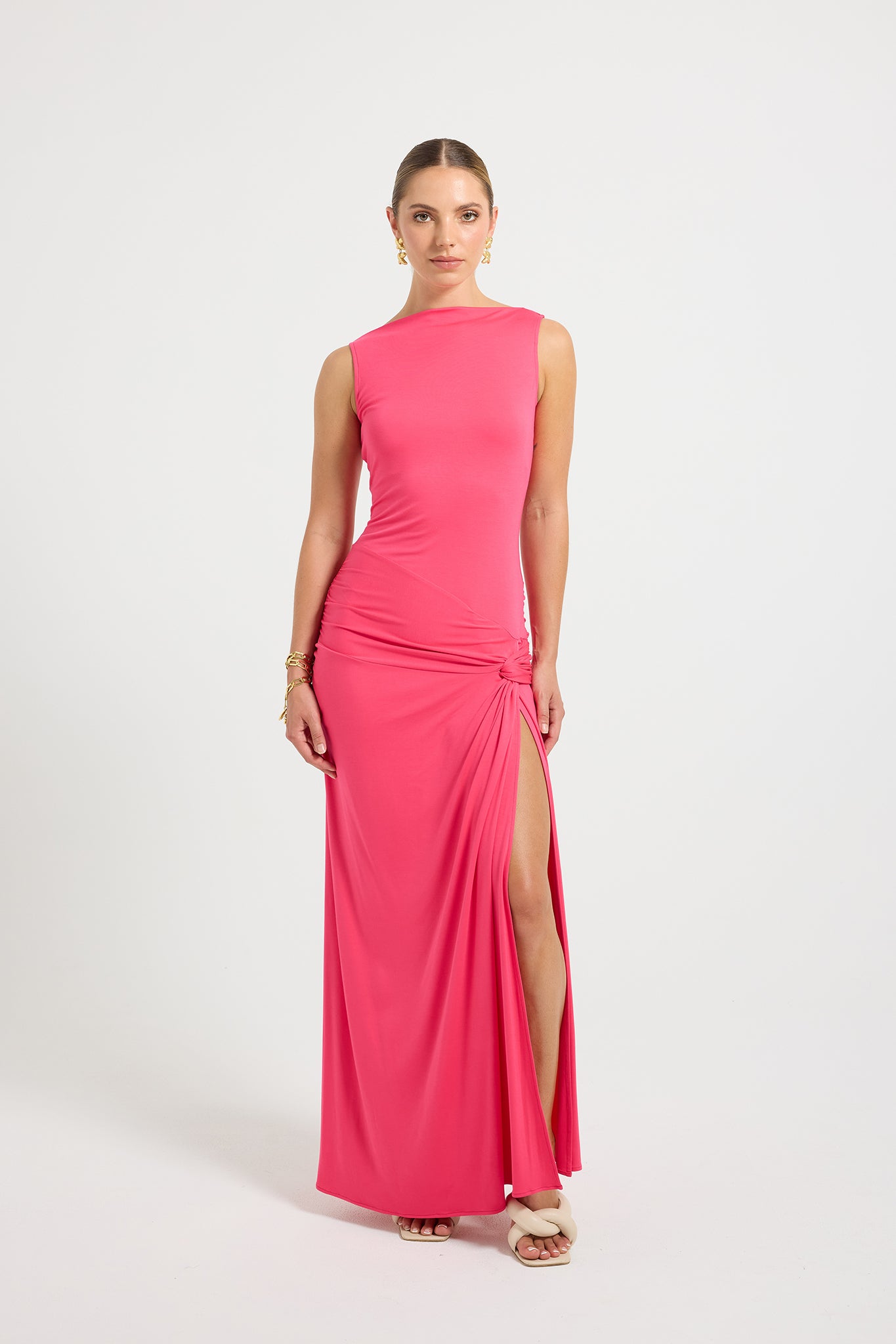 Woman wearing a hot pink evening gown with a slit