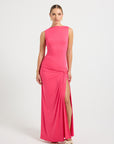 Woman wearing a hot pink evening gown with a slit