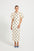 Woman wearing a Cream & Black polka dot Midi dress with short puff sleeves.