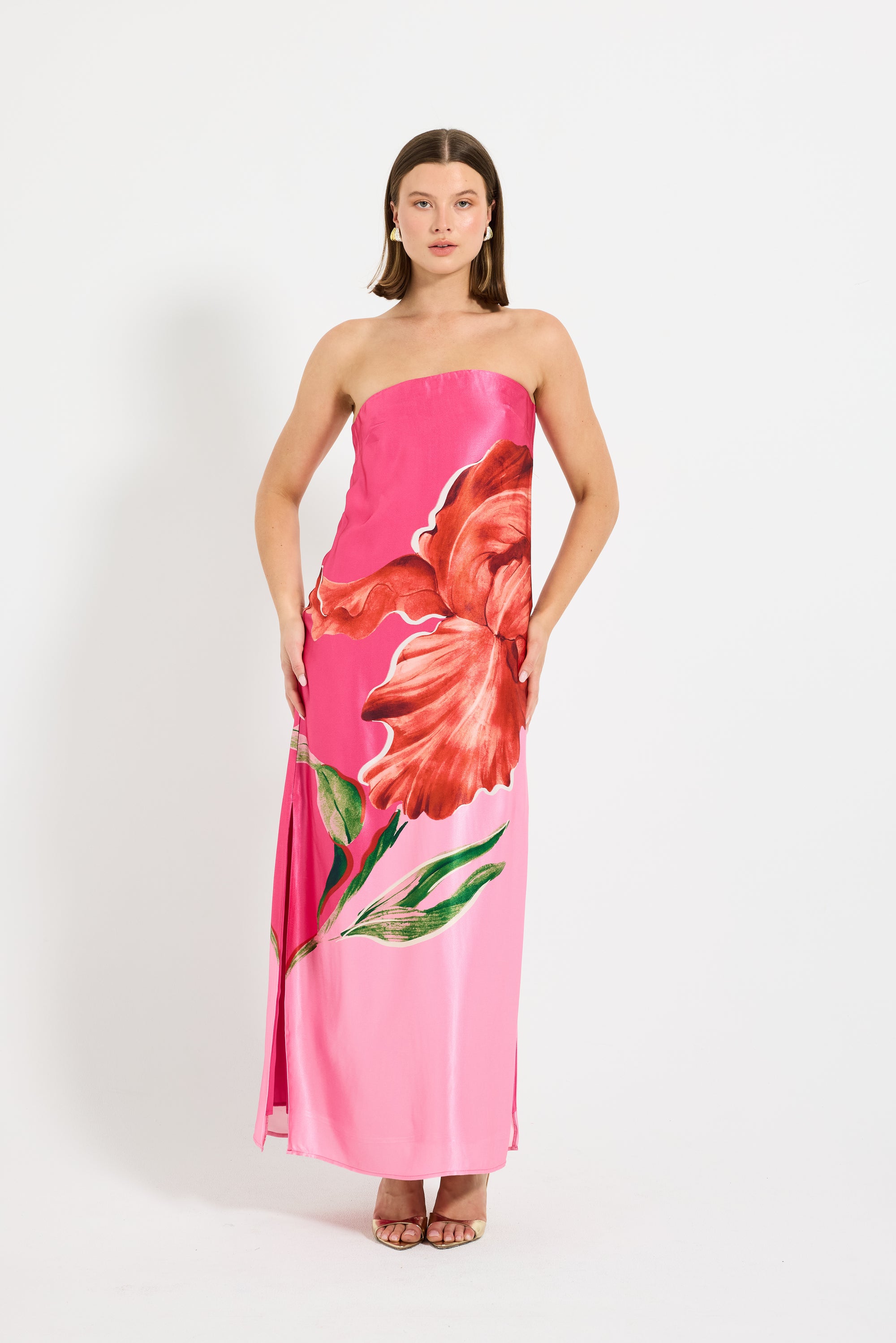 Model wearing a pink strapless maxi dress with floral design.