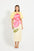 Woman wearing a yellow midi dress with puff sleeves with pink floral design. 